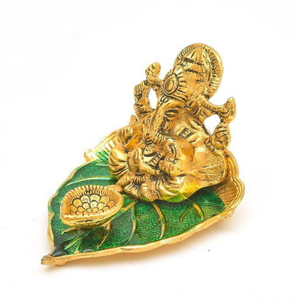 Elite Brass Metal Ganesh Ji Sitting on The Green Leave with Diya Deepak , Golden Decorative Showpiece - 9 cm  (Brass, Gold) - All Inclusive Family Treasures