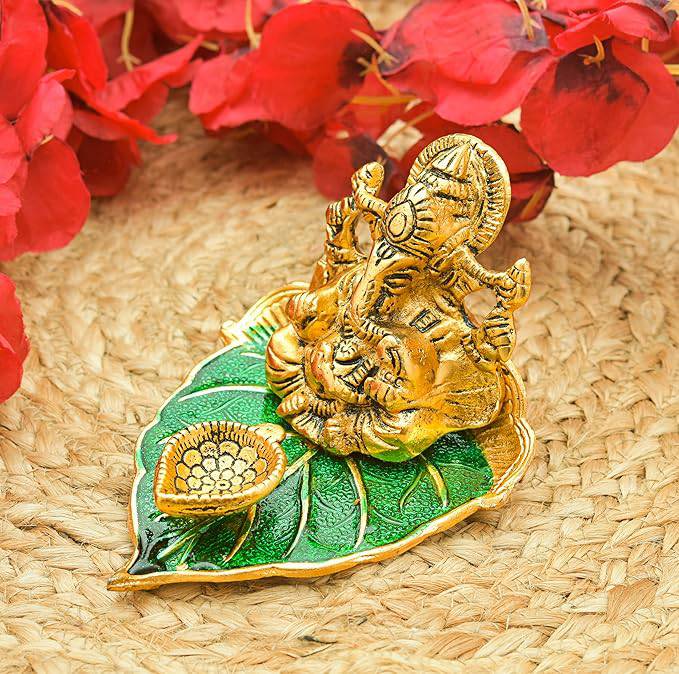 Elite Brass Metal Ganesh Ji Sitting on The Green Leave with Diya Deepak , Golden Decorative Showpiece - 9 cm  (Brass, Gold) - All Inclusive Family Treasures